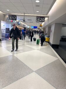 a group of people walking in a terminal
