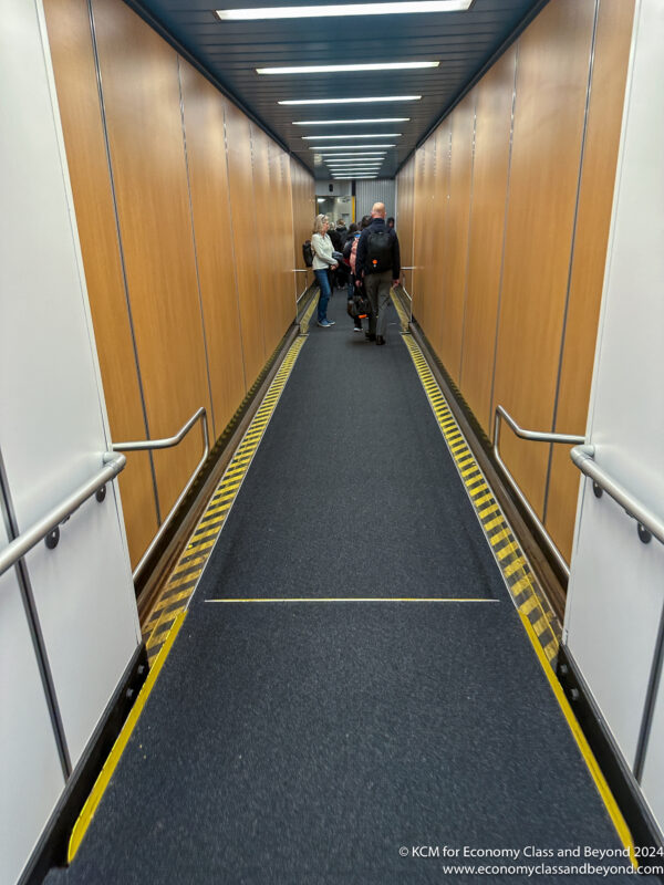 people walking down a hallway