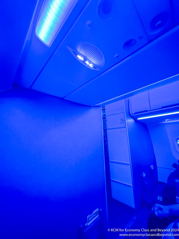a blue room with lights and a shelf
