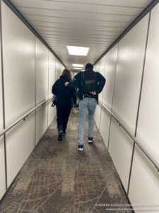 a man and woman walking down a hallway