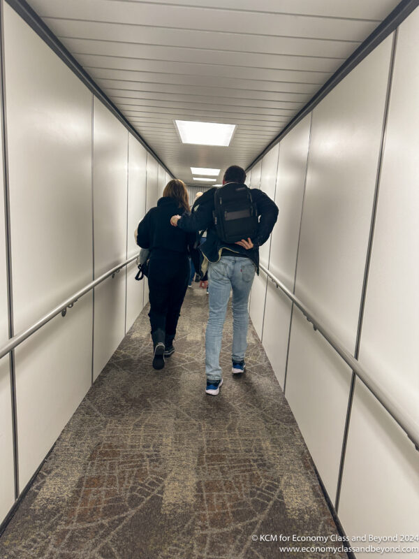 a man and woman walking down a hallway