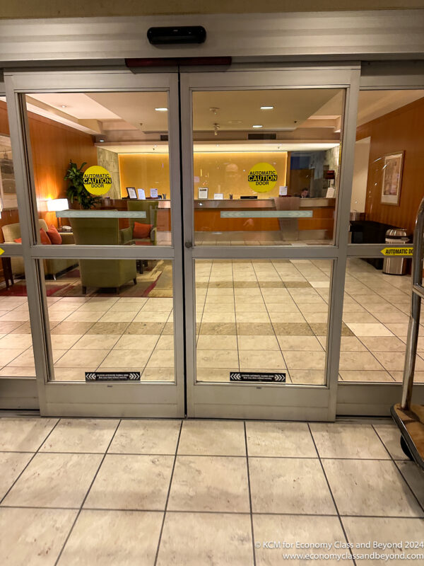a glass doors with a sign on the side