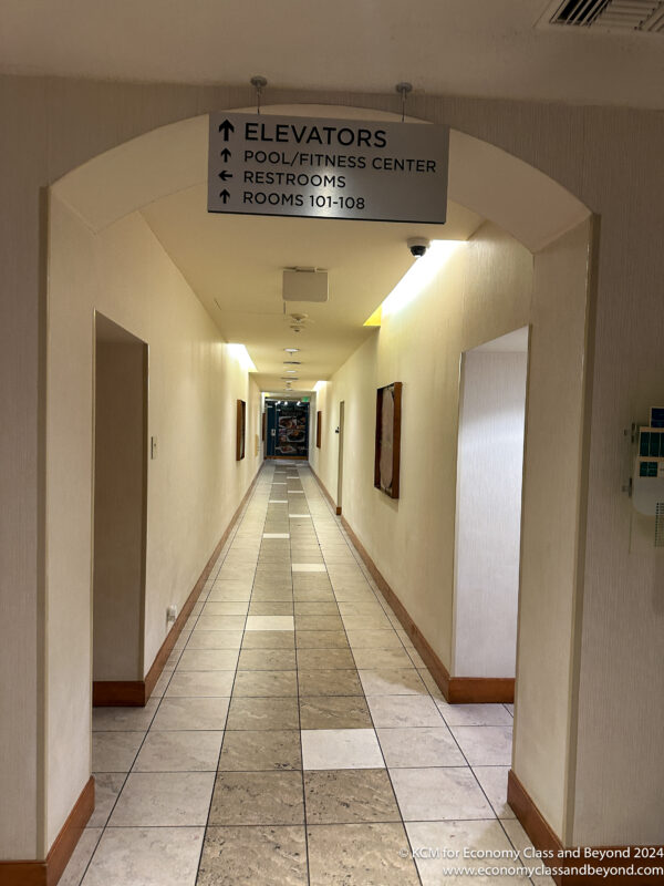 a hallway with a sign and a sign on the wall