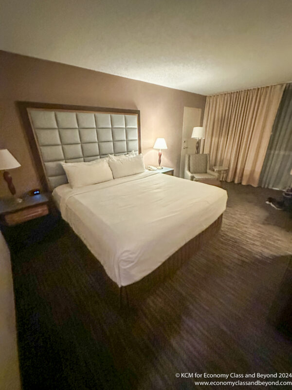 a hotel room with a bed and lamps