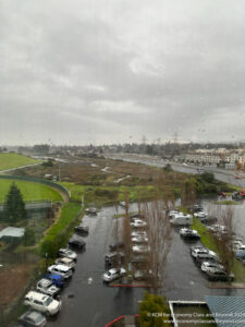 a view of a road and a parking lot from a window