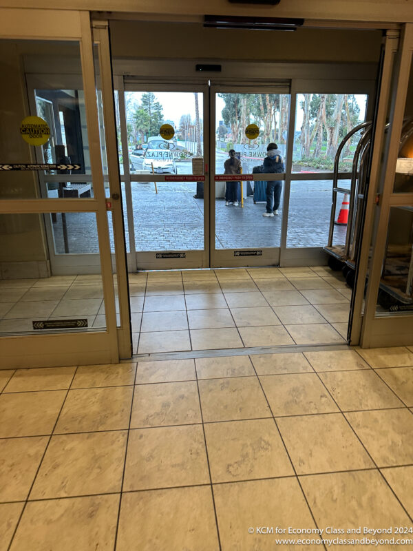 a glass doors with a couple of people standing outside