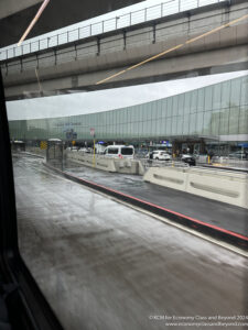 a view from a window of a building with a bridge and a road with cars