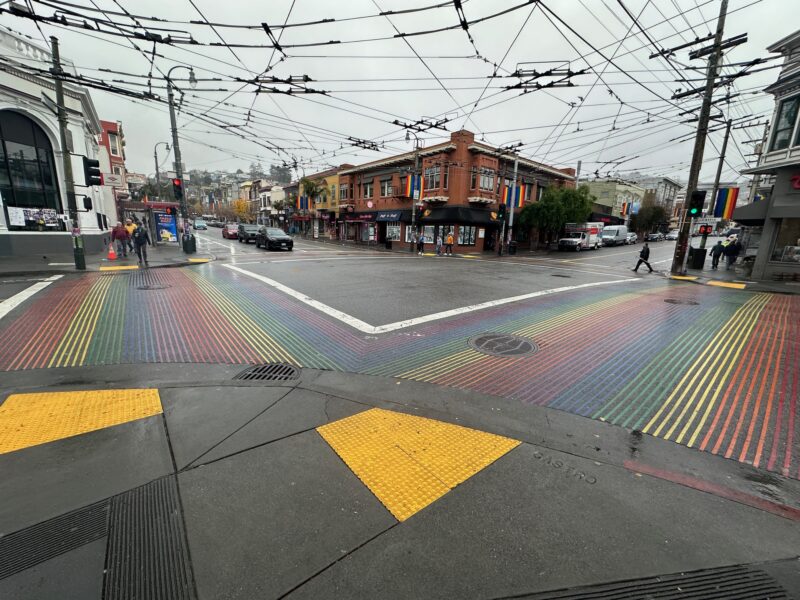 a crosswalk with a rainbow colored crosswalk
