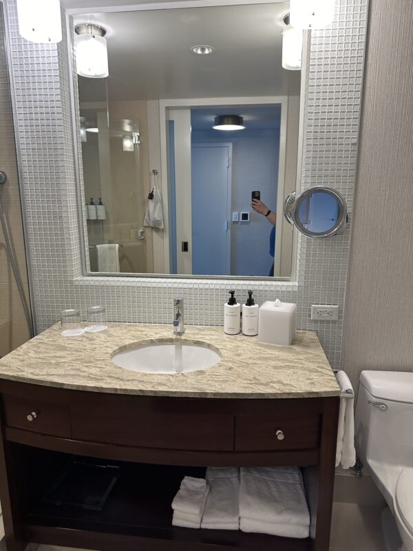 a mirror of a bathroom sink and toilet