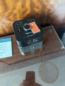 a black alarm clock on a glass table