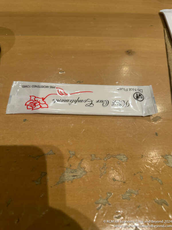 a white packet with red and black text on a table