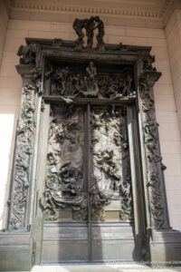 a large ornate door with statues on it