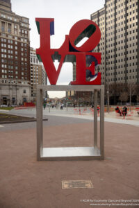 a sculpture of a love on a square in a city