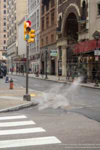a street light with smoke coming out of it
