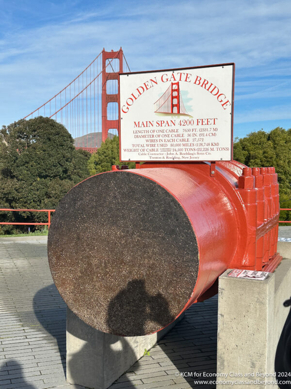 a large red pipe with a sign on top of it