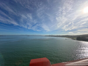 a body of water with a city in the distance