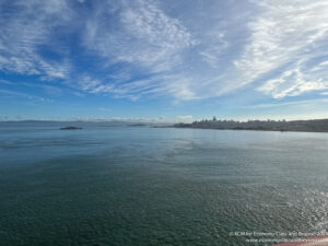 a body of water with a city in the background