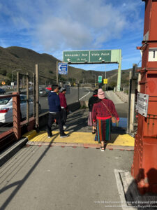 a group of people walking on a bridge