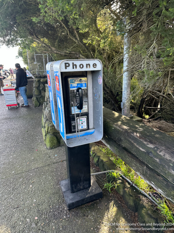 a pay phone on a sidewalk