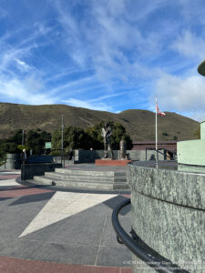 a statue in front of a mountain