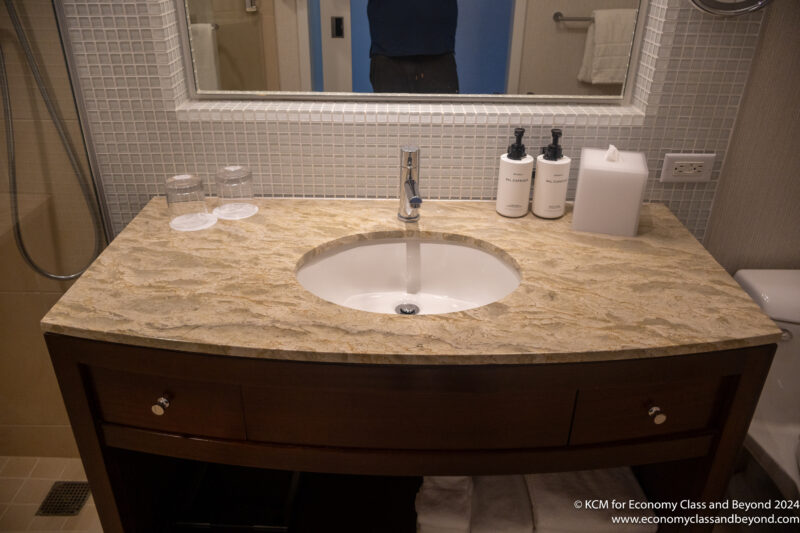 a sink with a mirror and a counter top