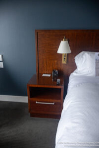 a bed with a lamp and a night stand
