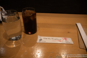 a glass of water and a drink on a table