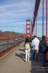 a group of people walking on a bridge