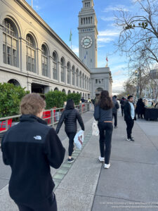 a group of people walking on a sidewalk