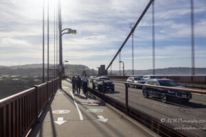 a group of people walking on a bridge