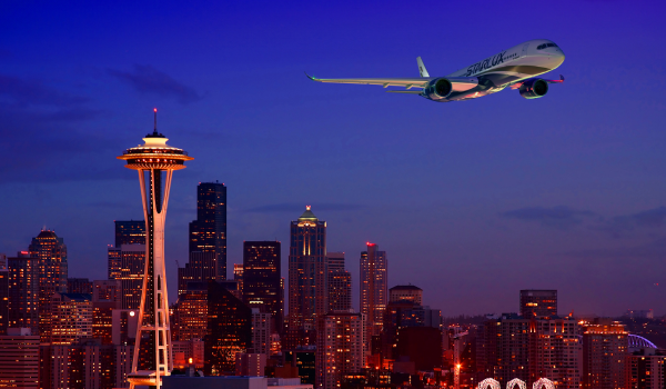 a plane flying over Space Needle