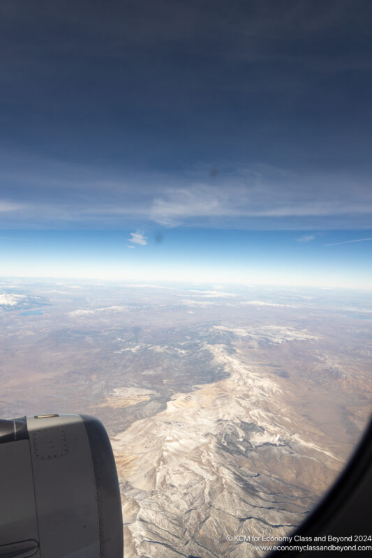 an airplane window overlooking a landscape