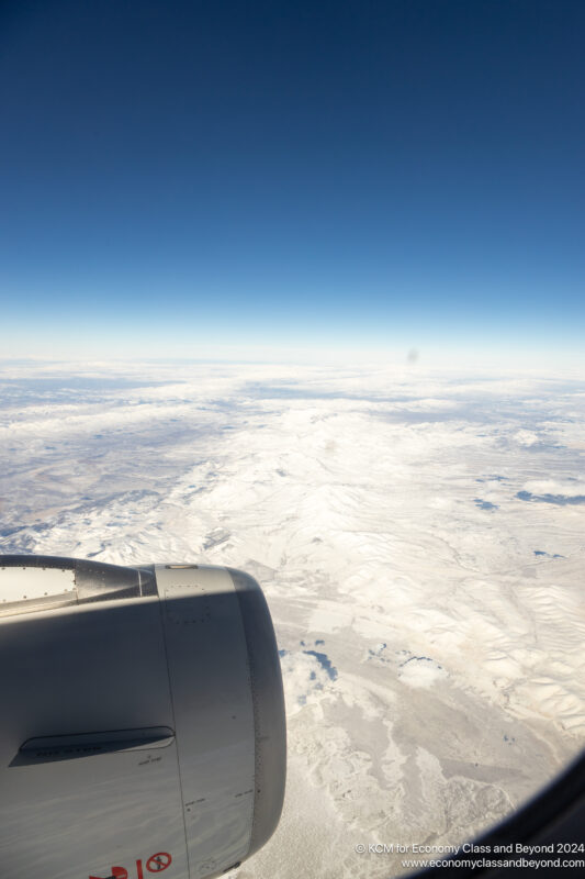 an airplane wing and a snowy landscape