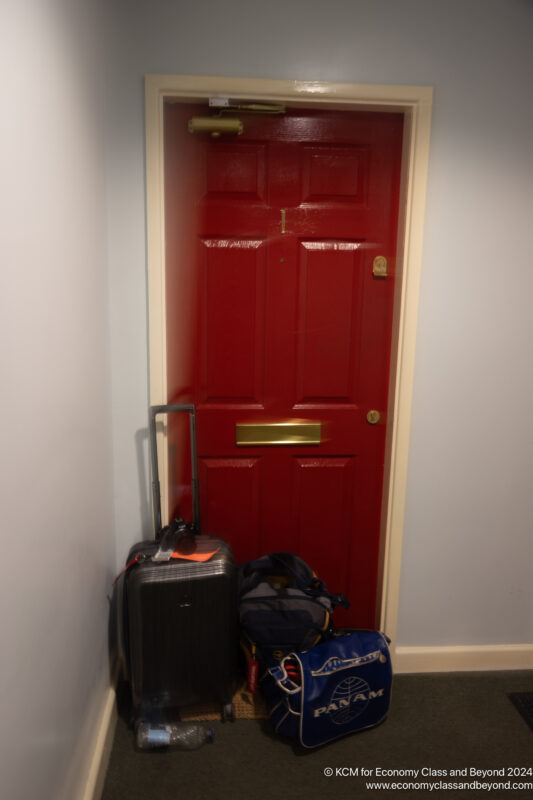 a red door with luggage on it