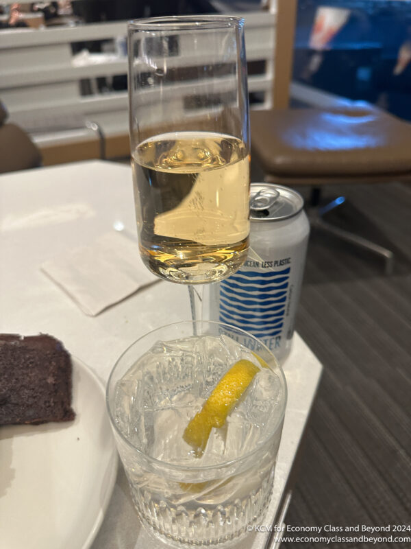 a glass of champagne with a lemon wedge in it