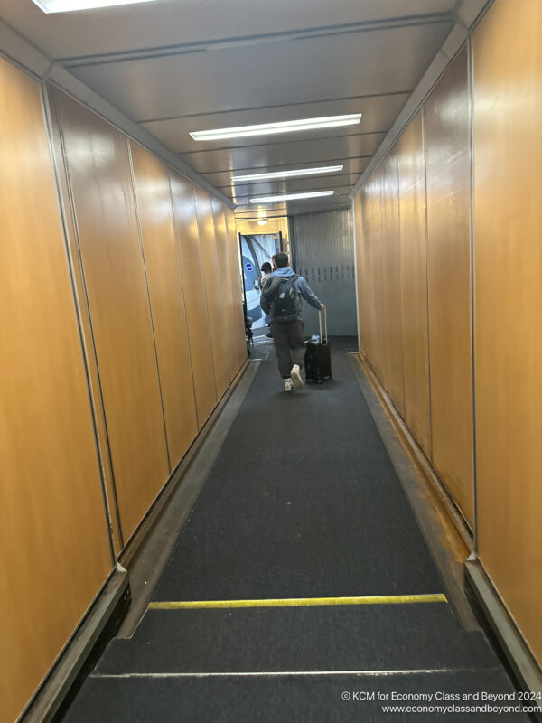 a person with luggage in a hallway