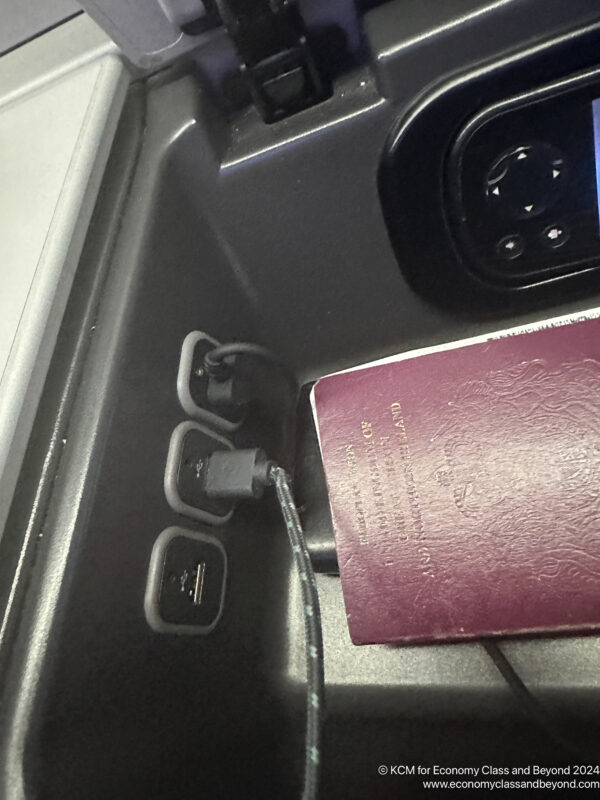 a passport and usb plugged into a charging station