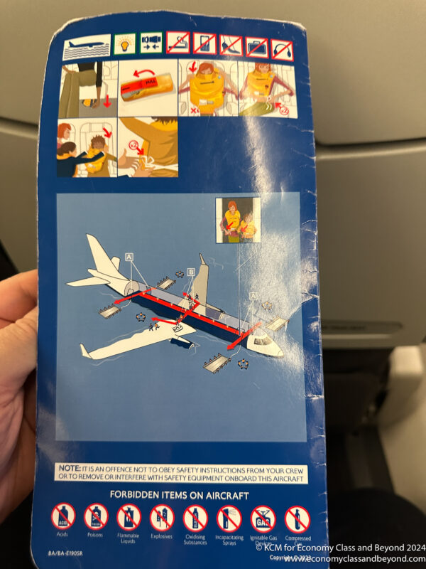 a hand holding a blue box with a picture of an airplane
