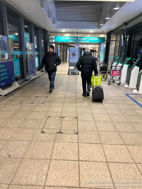 two people walking in a train station