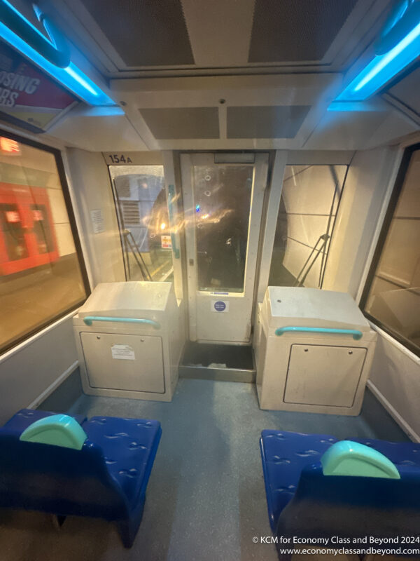 a train with blue seats and a door