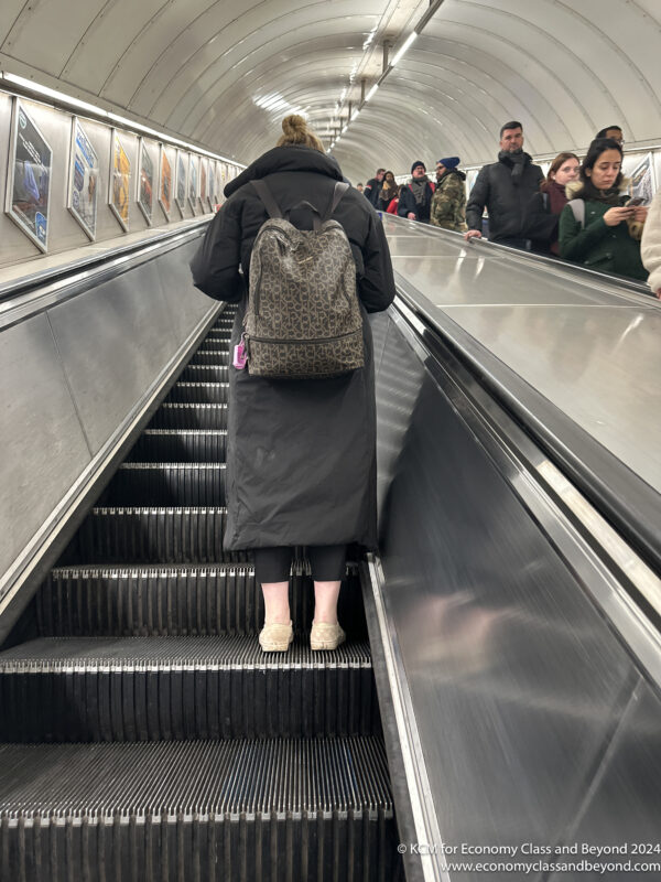 a woman standing on an escalator