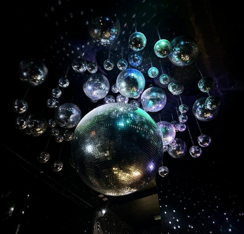 a group of disco balls from a ceiling