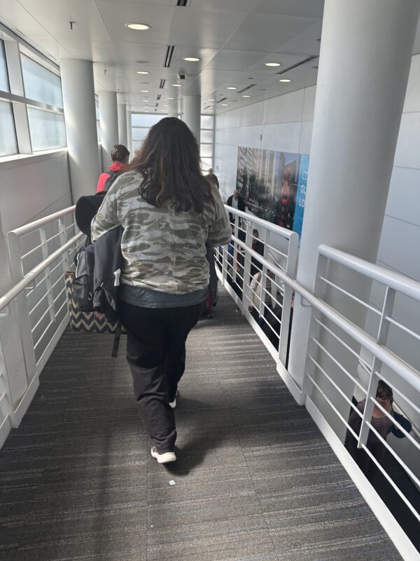 a woman walking down a hallway