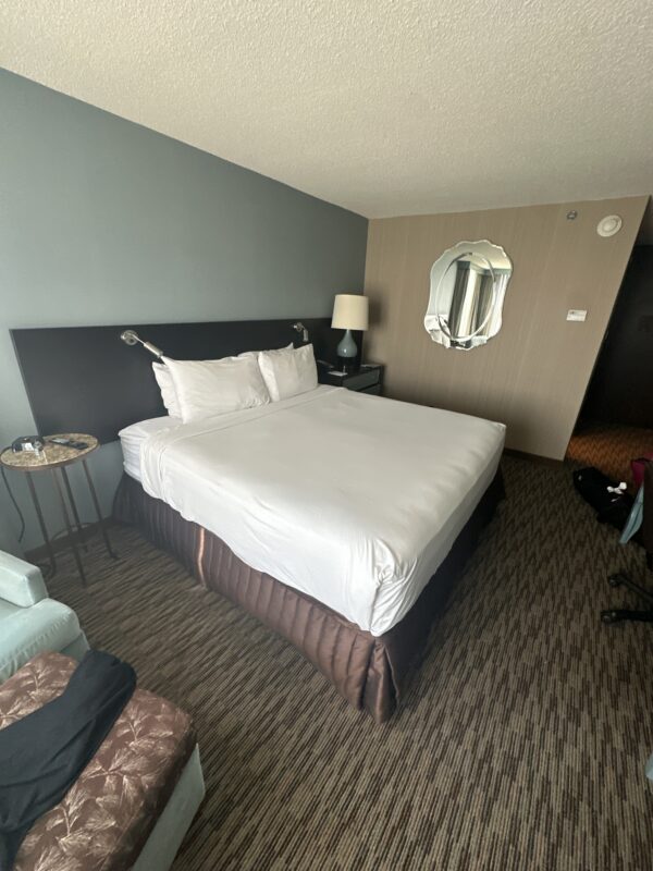 a hotel room with a bed and a mirror