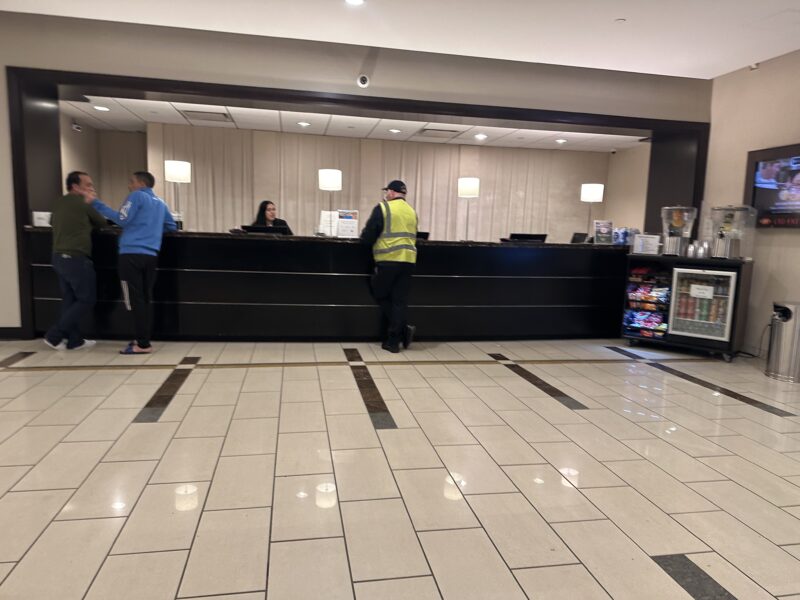 a man standing at a counter in a hotel