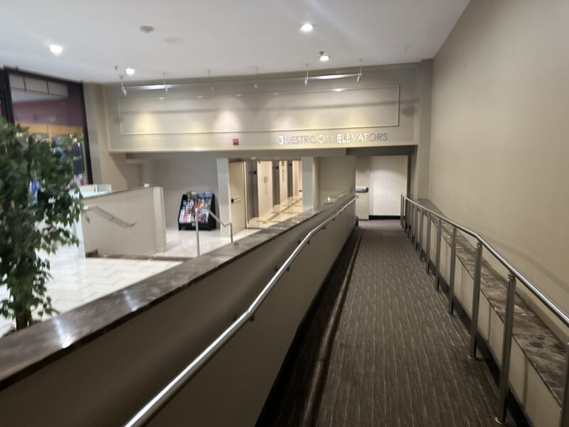 a walkway with a handrail in a building