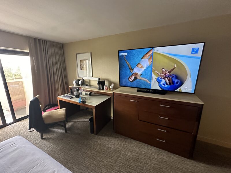 a television on a dresser in a hotel room