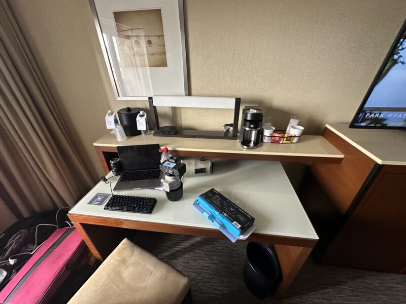 a desk with a computer and other objects on it