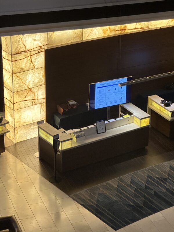 a reception desk with a screen and a tv