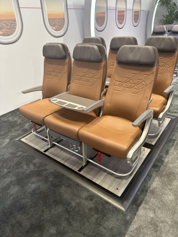 Collins Aerospace Meridian Seats - Image, Economy Class and Beyond (cocktail tray deployed)